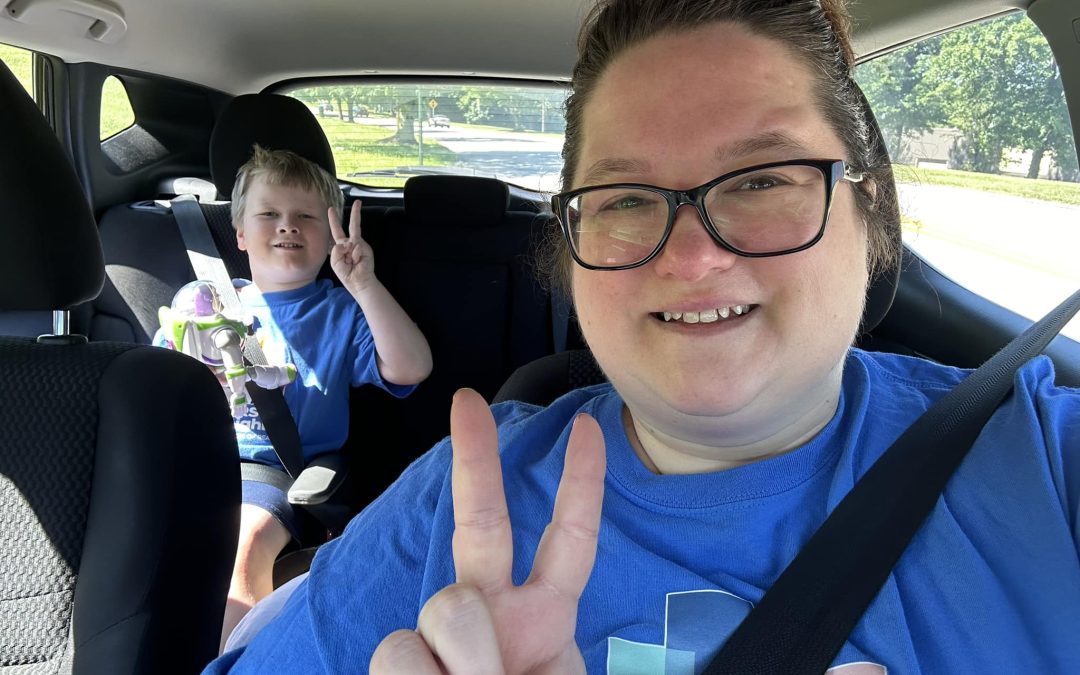 Sarah and her son in a car delivering groceries for CCC