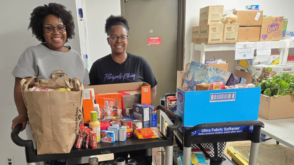 2 volunteers with bags of food at a CCC pantry
